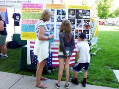 A family examines one of the posters.