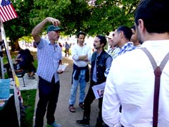 Enthusiastic fair-goer talks to  friends.